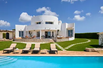 a villa with a swimming pool in front of a house at Casa Rosa dos Ventos in Guia