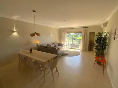 a living room with a table and a couch at Luxury ground-floor appartment 5 stars, 2 bedrooms, 2 bathrooms, Free Wifi in Albufeira