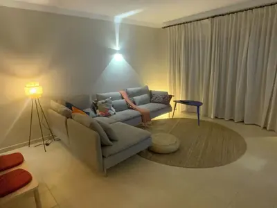 a living room with a couch and a table at Luxury ground-floor appartment 5 stars, 2 bedrooms, 2 bathrooms, Free Wifi in Albufeira