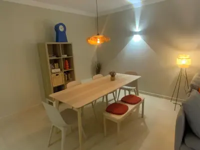 a table and chairs in a living room with a light at Luxury ground-floor appartment 5 stars, 2 bedrooms, 2 bathrooms, Free Wifi in Albufeira