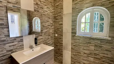 a bathroom with a sink and a window at Laranjal by Check-in Portugal in Quarteira