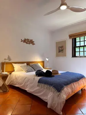 a bedroom with a bed with a cat laying on it at Amazing T3 -Clube Albufeira in Albufeira