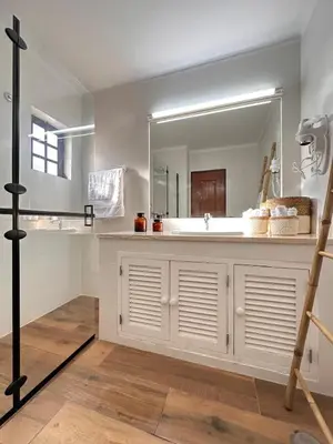 a bathroom with a sink and a large mirror at Amazing T3 -Clube Albufeira in Albufeira