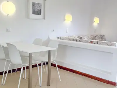 a table and chairs in a room with a bed at Aura Village - City Beach Apartments in Albufeira