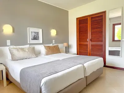 a bedroom with a large bed and a window at Aura Village - City Beach Apartments in Albufeira