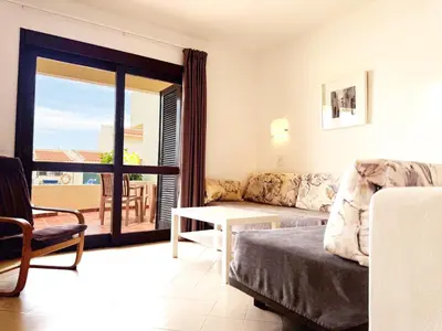 a living room with a couch and a table at Aura Village - City Beach Apartments in Albufeira