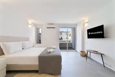 a bedroom with a bed and a tv on a wall at Downtown Apartment - BE by HelloVacations in Albufeira