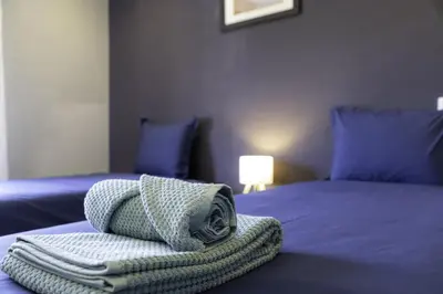 a room with a bed with a towel on it at CORCOVADA SUNSET Just 5 min from the Strip in Albufeira