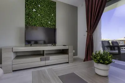 a living room with a television and a couch at CORCOVADA SUNSET Just 5 min from the Strip in Albufeira