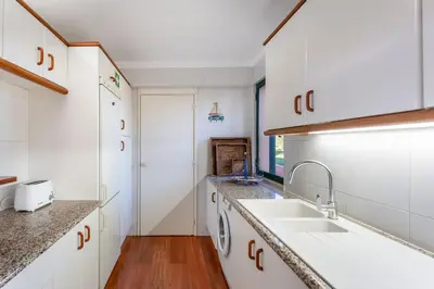 a kitchen with white cabinets and a sink at Pearl Harbor 3 BDR Flat VLM Marina by LovelyStay in Quarteira