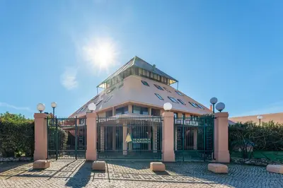a large building with the sun behind it at Pearl Harbor 3 BDR Flat VLM Marina by LovelyStay in Quarteira