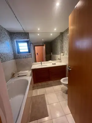 a bedroom with a bed and a window and a door at Vilamoura townhouse in private gated condominium in Quarteira