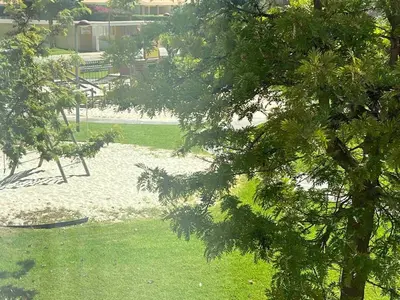 a view of a park with trees and a playground at Vilamoura townhouse in private gated condominium in Quarteira