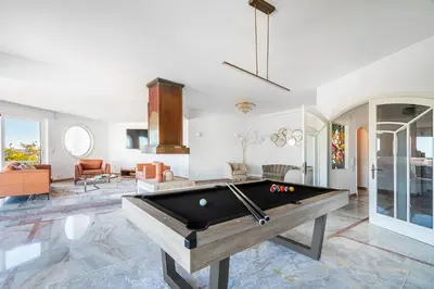 a white bedroom with a bed and a desk at Luxe Penthouse, BBQ, hot spa, games, ocean view - By Seareen in Albufeira