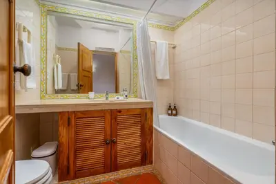 a bathroom with a tub and a toilet and a sink at Pool Apartment Vilamoura near Old Village in Quarteira