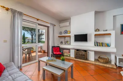 a living room with a couch and a table at Pool Apartment Vilamoura near Old Village in Quarteira