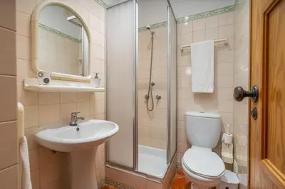 a bathroom with a toilet and a sink and a shower at Pool Apartment Vilamoura near Old Village in Quarteira