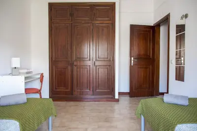 a room with two chairs and a wooden door at Fernando Pessoa Villa in Faro