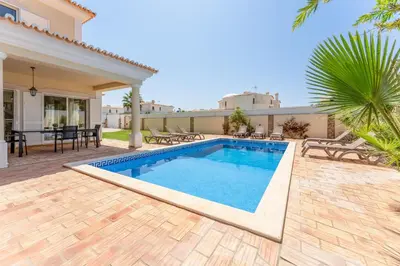 a swimming pool in the backyard of a house at Villa Castelo by Algarve Holidays in Albufeira