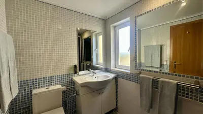 a bathroom with a sink and a toilet and a window at Wave by Check-in Portugal in Albufeira