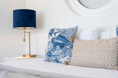 a bedroom with a bed with a pillow and a lamp at Casa Aurora in Vale do Lobo