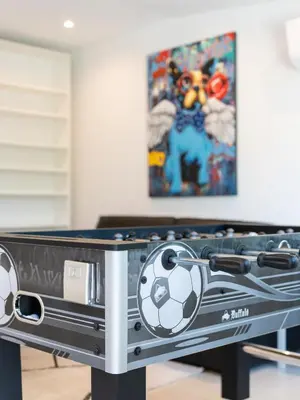 a ping pong table with a soccer ball on it at Casa Aurora in Vale do Lobo