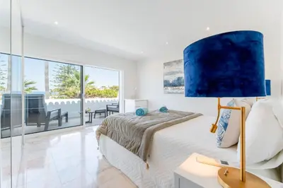 a bedroom with a bed and a blue lamp at Casa Aurora in Vale do Lobo