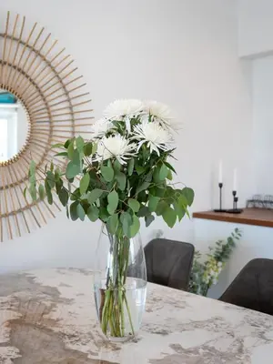 a vase of white flowers sitting on a table at Casa Aurora in Vale do Lobo
