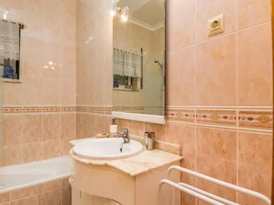 a bathroom with a sink and a tub at Akisol Olhos de Agua Prize in Albufeira