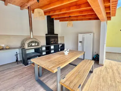 a kitchen with a wooden table and a stove at Villa 20age - Jacuzzi - Heated pool - Algarve in Albufeira
