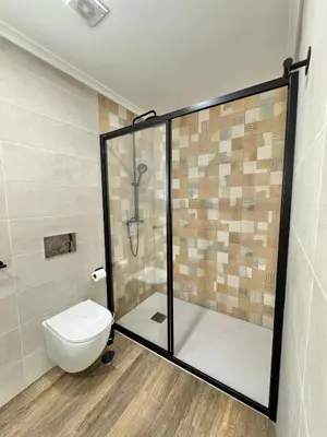a bathroom with a toilet and a glass shower at Villa 20age - Jacuzzi - Heated pool - Algarve in Albufeira