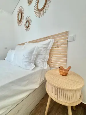 a bedroom with a bed and a wooden table at Villa 20age - Jacuzzi - Heated pool - Algarve in Albufeira