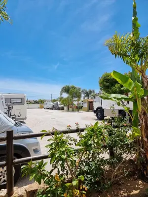 a car parked in a parking lot with a trailer at Casinha da Galé in Galé