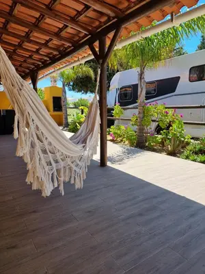 a hammock on a patio with a roof at Casinha da Galé in Galé