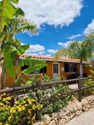 a house with a fence and flowers in front of it at Casinha da Galé in Galé