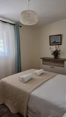 a bedroom with a bed with two towels on it at Casinha da Galé in Galé
