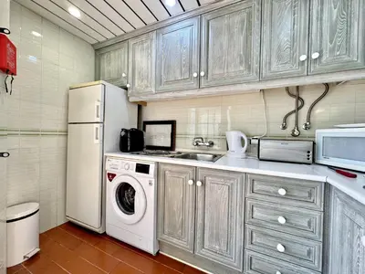 a kitchen with a white refrigerator and a washing machine at Vilamoura Marina View 3 by Homing in Vilamoura