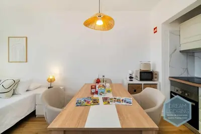 a living room with a wooden table and a couch at Alamos - Dream Lodging in Albufeira