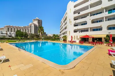 a large swimming pool in front of a building at Alamos - Dream Lodging in Albufeira