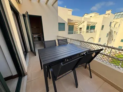 a black table and chairs on a balcony at T1 dos Salgados in Guia