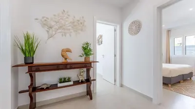a bedroom with a table with plants on it at Vivenda Neves in Albufeira by LovelyStay in Vale de Pedras