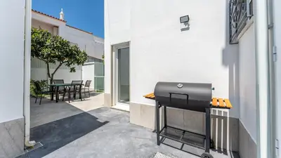a barbecue grill on the side of a building at Vivenda Neves in Albufeira by LovelyStay in Vale de Pedras