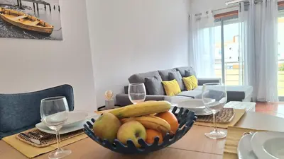 a bowl of fruit on a table with wine glasses at albufeira sweety house in Albufeira