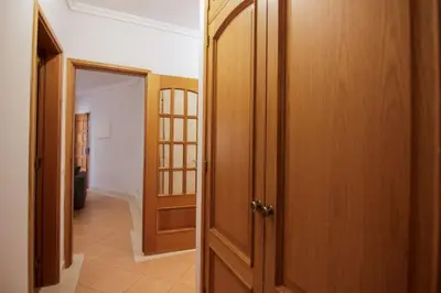 a hallway with an open door to a room at Modern 3-bedroom Retreat in Faro's City Center in Faro