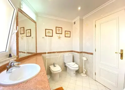 a bathroom with a sink and a toilet at Vilamoura Central in Quarteira
