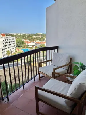 a balcony with two chairs and a view of a city at LizHolidays in Albufeira