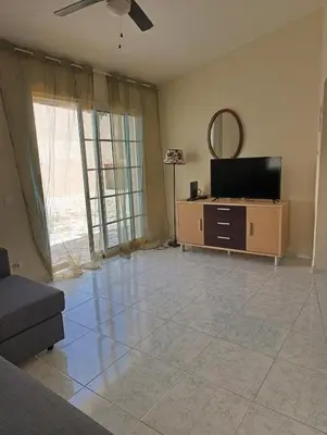a living room with a flat screen tv and a couch at Casa Gomez C in Albufeira