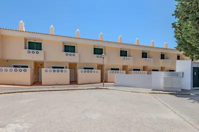 an empty parking lot in front of a building at Sao Rafael TownHouse with Pool in Albufeira
