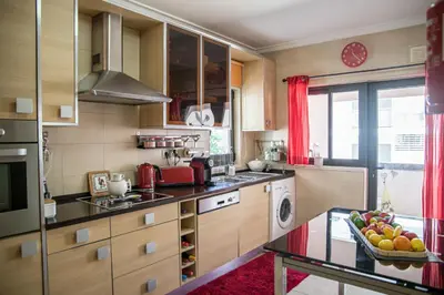 a kitchen with a bowl of fruit on a table at Apartamento Dubai By Garvetur in Quarteira