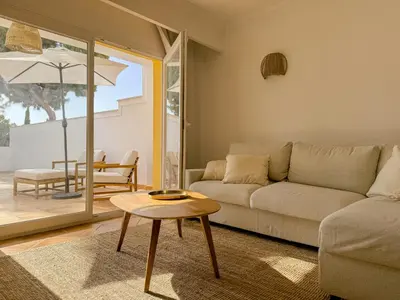 a living room with a couch and a table at Casa Vaga - Garrão beach House